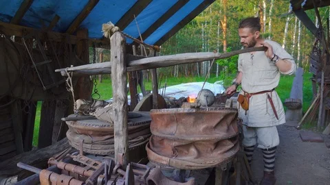 Blacksmith working with blacksmith furs in forge. Stock Footage 108825207