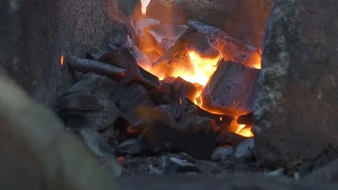 Blacksmith working with blacksmith furs in forge. Fire close-up. Stock Footage 108826576
