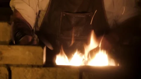 Blacksmith Working at Fiery Forge with Sparks in Traditional Workshop Close Up Stock Footage 339239557