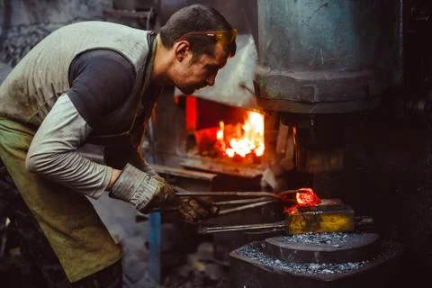 Blacksmith working in the forge Stock Photos