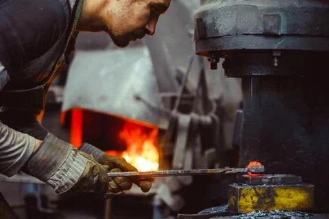 Blacksmith working in the forge Stock Photos