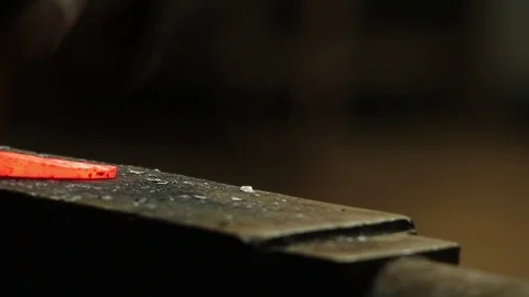 Blacksmith working with a glowing hot pice of iron on anvil Stock Footage 72218408