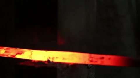 Blacksmith working with a glowing hot pice of iron Stock Footage 72219700
