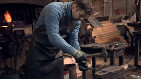 Blacksmith working with a hammer on anvil Stock Footage 132652908