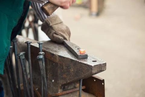Blacksmith working with a hammer. Stock Photos