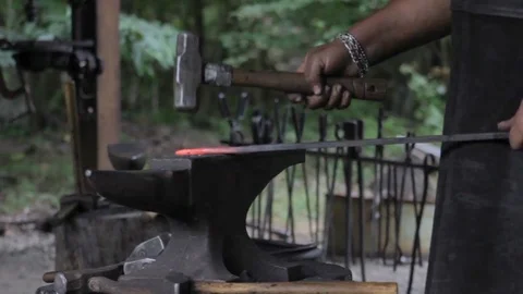 BLACKSMITH WORKING HEATED IRON ON AN ANVIL Stock Footage 84291546