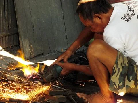 Blacksmith working at his workshop Stock Photos