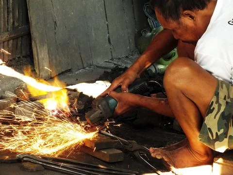 Blacksmith working at his workshop Stock Photos