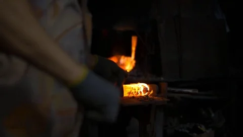 Blacksmith working with hot glowing metal, bending steel in a smithery Stock Footage 71391131