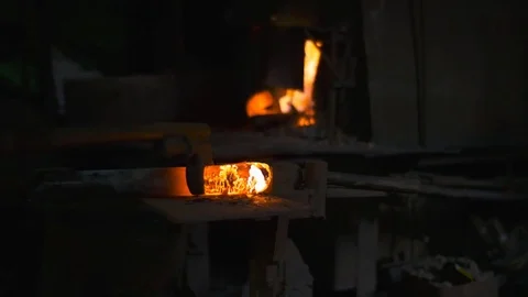 Blacksmith working with hot glowing metal, bending steel in a smithery Stock Footage 71391685