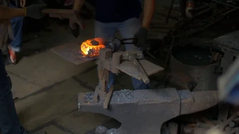 Blacksmith working with hot glowing metal, bending steel in a smithery Stock Footage 71391687