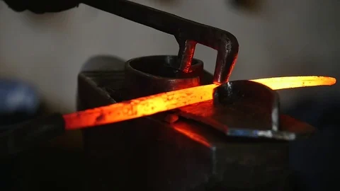 Blacksmith working with hot glowing metal, bending steel in a smithery, slow 스톡 동영상 79148795