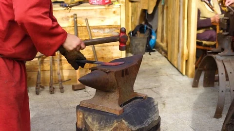 Blacksmith working with iron the medieval way Stock Footage 127381951