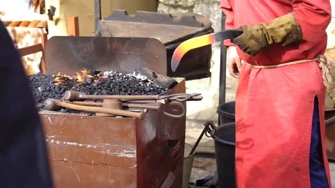 Blacksmith working with iron the medieval way Stock Footage 127382099