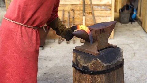 Blacksmith working with iron the medieval way Stock Footage 127382363