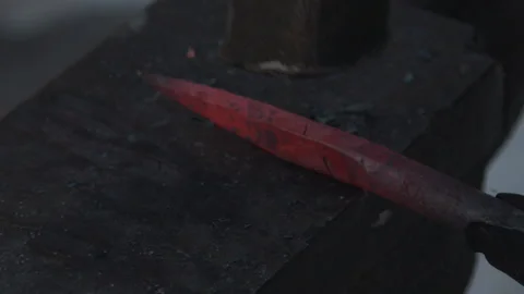 Blacksmith working on metal on anvil at forge high speed detail shot Stock Footage 87875832