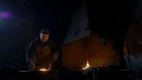 Blacksmith working with metal at the forge Stock Footage 69858277