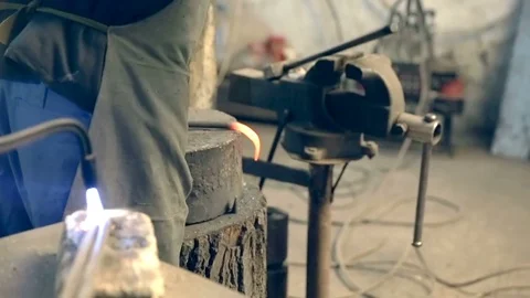Blacksmith working metal with hammer on the anvil in the forge Stock Footage 77032357