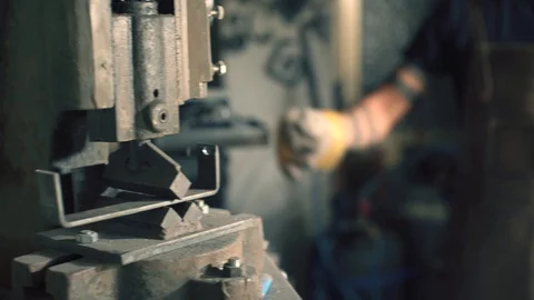Blacksmith working metal with a press Stock Footage 128597447
