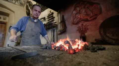 Blacksmith working near the hot stove Stock Footage