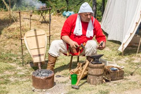 Blacksmith working outdoors Stock Photos
