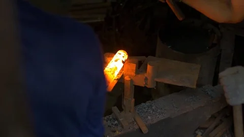 Blacksmith working in a smithery forging glowing hot metal and sparks fly Stock Footage 71391974