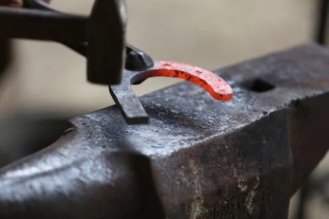 Blacksmith working at smithy workshop Stock Photos