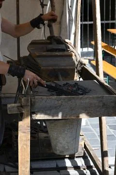 Blacksmith working at a traditional forge 스톡 사진