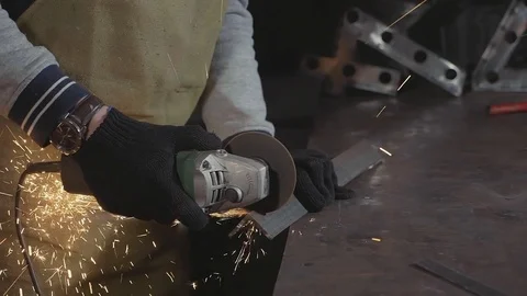 Blacksmith working in a workshop with metal via angle grinder, slow motion. Stock Footage 83769475
