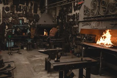 Blacksmith working in workshop Stock Photos