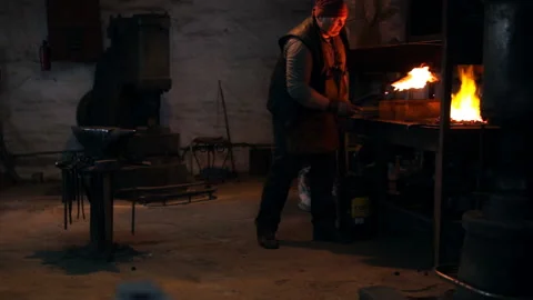 Blacksmith works in the forge Stock Footage 99837453