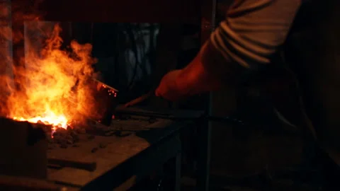 Blacksmith works in the forge Stock Footage 100267887