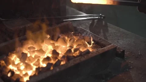 A blacksmith works with metal in a forge. Man prepares iron Video stock 298870918