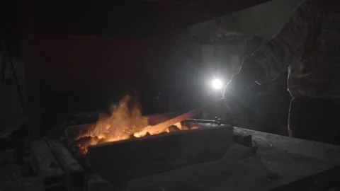 A blacksmith works with metal in a forge. Man prepares iron Video stock 298871147