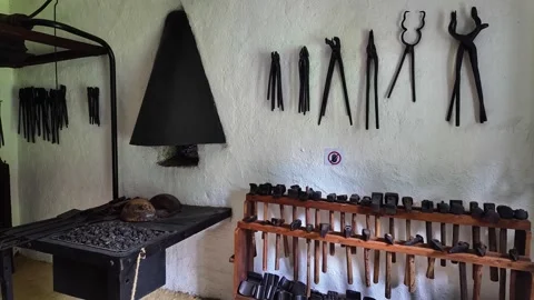 A blacksmith workshop display with tools, an anvil and a forge in Makó museum Stock Footage 336505661