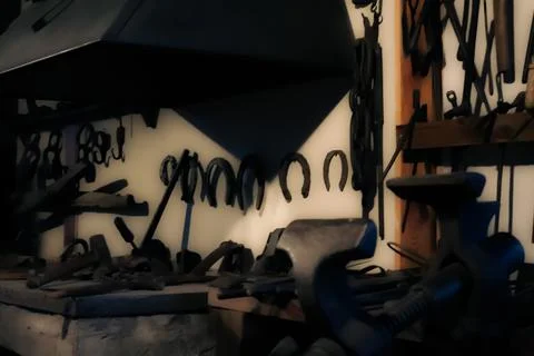 Blacksmith workshop with hanging tools and horseshoes Stock Photos