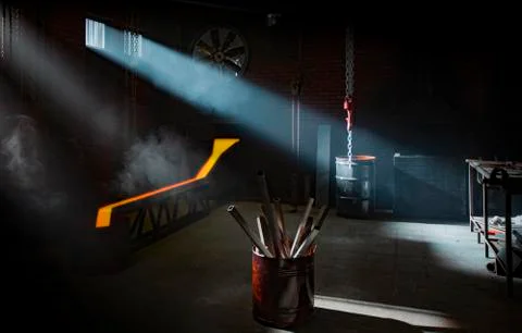 Blacksmith workshop interior with lightrays coming from windows Stock Photos