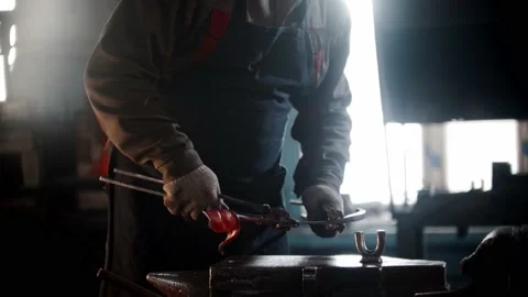 Blacksmith workshop - a man works with heated detail using forceps Stock Footage 180500804