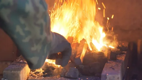 Blacksmithing: heating up the steel in a coal forge in UHD Stock-Footage 91799624