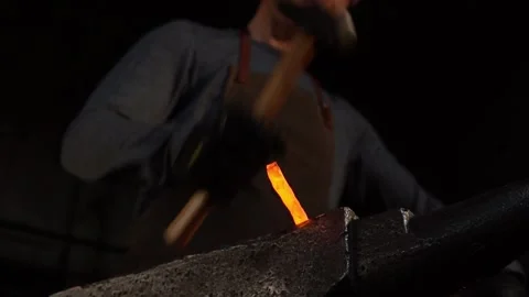 Blacksmithing Hot Metal with Slow Motion Sparks in Forge Stock Footage 255408875