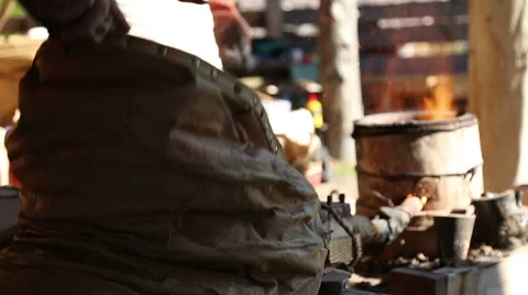 The blacksmith's assistant is working the bellows Stock Footage 54688045