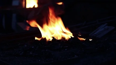 Blacksmiths coals burning for iron work Stockbeeldmateriaal 83475901