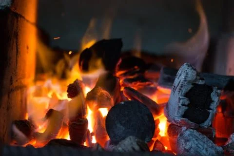 Blacksmiths coals burning for iron work Stock Photos