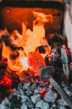 Blacksmiths coals burning for iron work Stock Photos