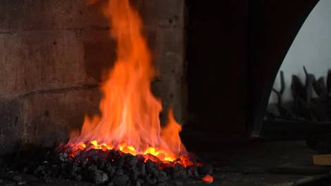A Blacksmith's Craft: The Art of Forging Metal in a Fiery Hearth, Showcasing Stock Footage 341316693