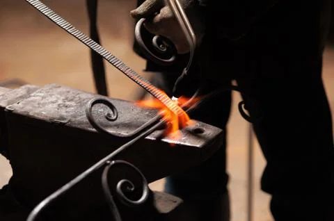 Blacksmith's Hand In Protective Gloves Solder A Metal Stock Photos