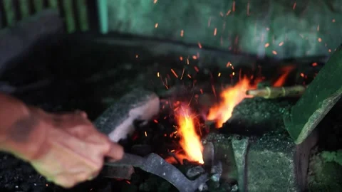 Blacksmith's hands adjusting the flame Stock Footage 272287850