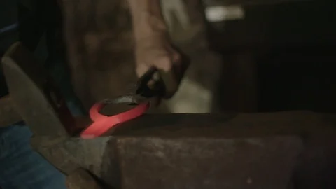 Blacksmith's hitting metal with hammer Stockbeeldmateriaal 89327888