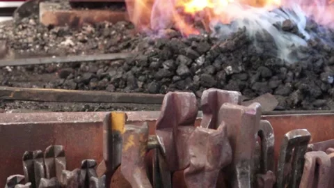 Blacksmiths tongs with forge fire in the background Stock Footage 133015351