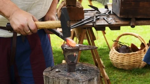 Blacksmiths at work in slow motion with anvil and forge hammering metal Stock Footage 118497125